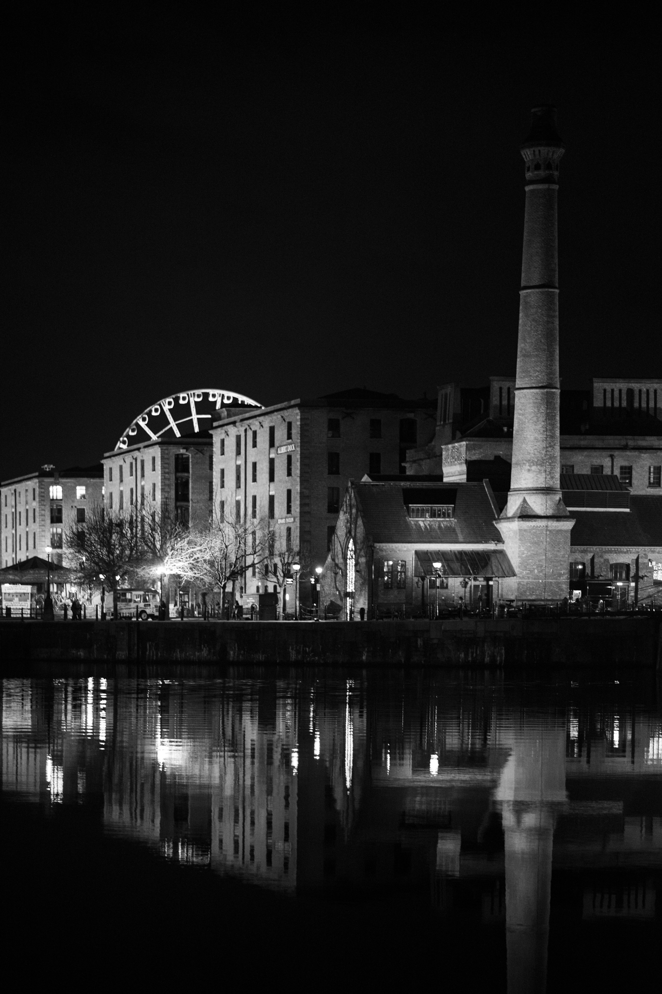 Black and white nighttime industrial waterfront